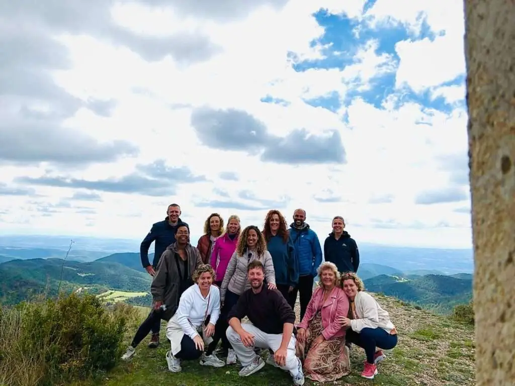 groepsfoto van deelnemers met vallei op de achtergrond.